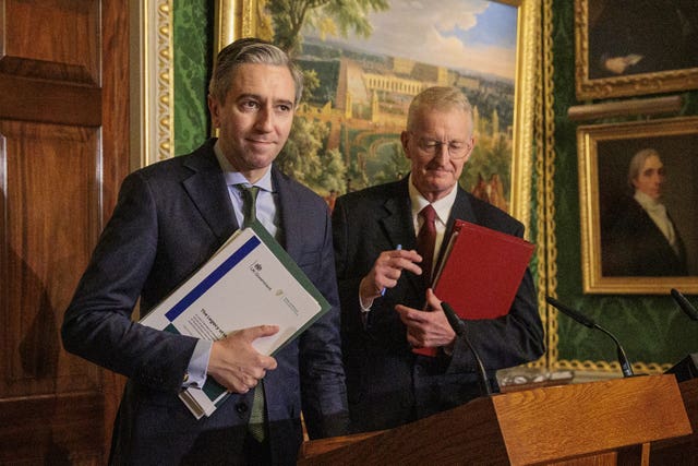 Simon Harris and Hilary Benn leave the room after holding a press conference