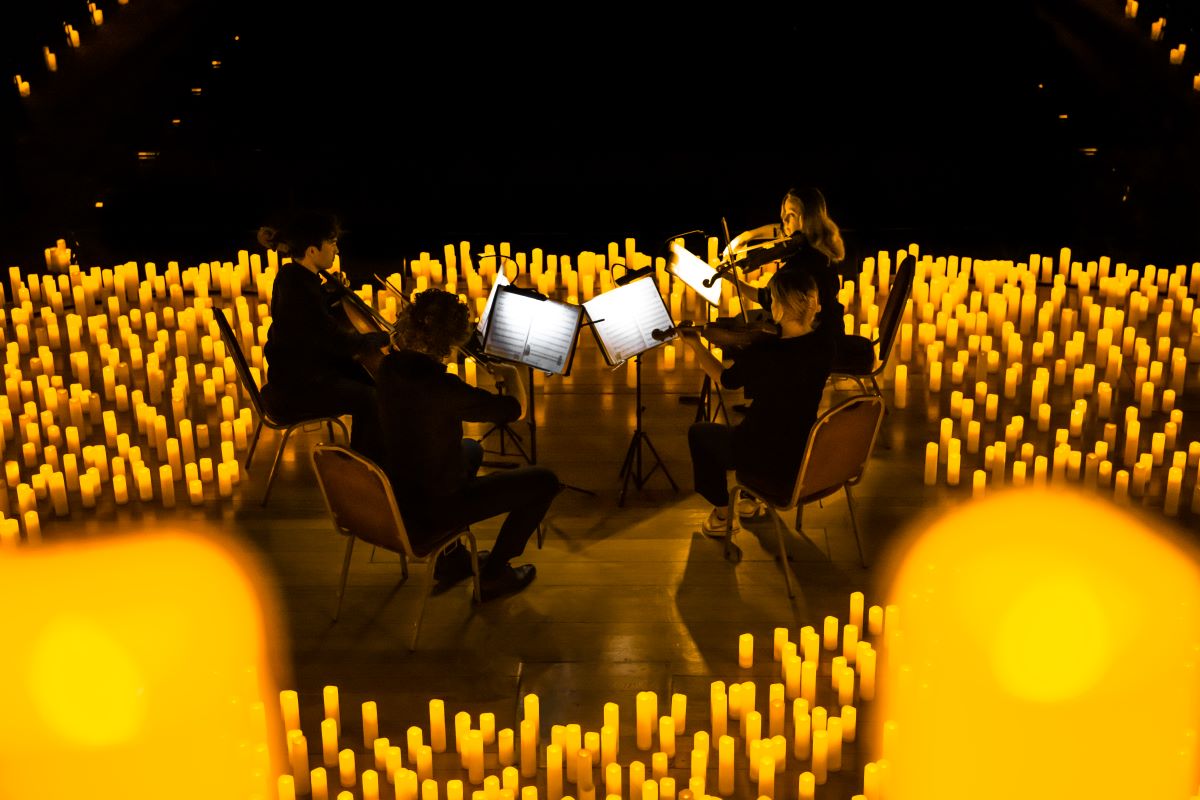 A string quartet performing by candlelight at Central Hall Westminster