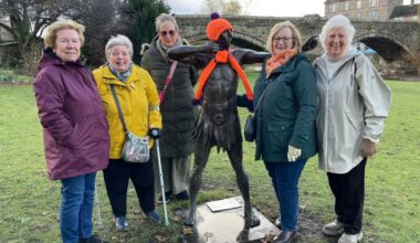 Inner Wheel club dress up archer sculpture in orange