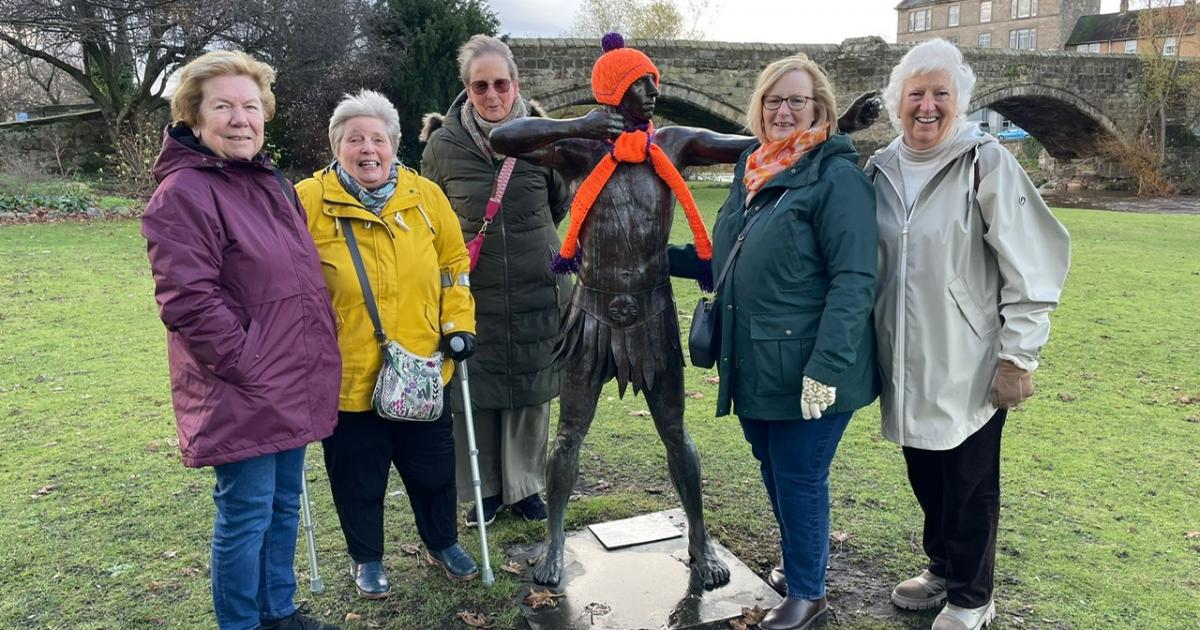 Inner Wheel club dress up archer sculpture in orange