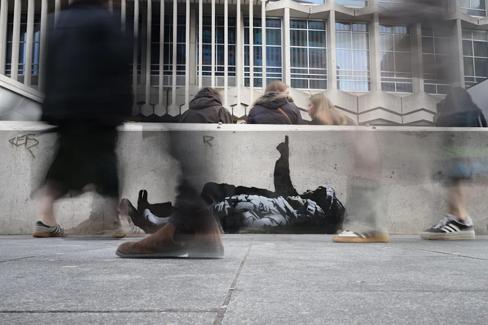 Shoppers walk past an apparent Banksy artwork which has appeared on a wall near to the Centrepoint building on Dec. 22, 2025 in London, England.  / Credit: Leon Neal/Getty Images