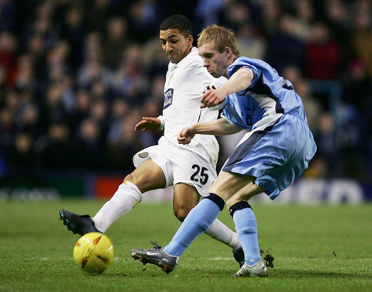 Aaron Lennon of Leeds United is tackled Stuart Giddings of Coventry City during the Coca-Cola Football League Championship match between Coventry City and Leeds United