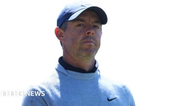 Rory McIlroy pictured outdoors with green trees in the background.