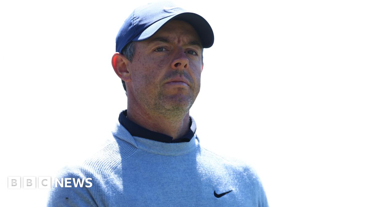 Rory McIlroy pictured outdoors with green trees in the background.