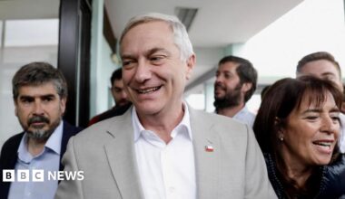 Jose Antonio Kast, presidential candidate of the far-right Republican Party of Chile, and his wife Maria Pia Adriasola Barroilhet, arrive at a polling station to vote during a presidential runoff election
