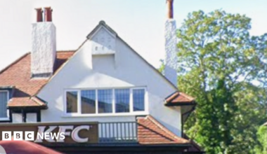 Close-up of KFC branch in West Wickham, showing the gable roof and top windows, as well as chimneys of the building