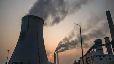 Bloomberg via Getty Images A cooling tower and chimneys at the NLC Tamil Nadu Power Ltd. (NTPL) power plant in Tuticorin, India, on Monday, March 18, 2024. 