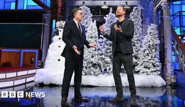 Stephen Colbert and Prince Harry on the set of the show with fake snow, Christmas trees and a snowman