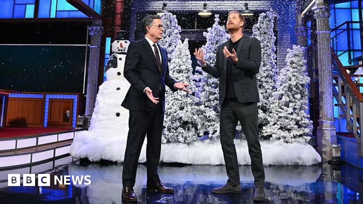 Stephen Colbert and Prince Harry on the set of the show with fake snow, Christmas trees and a snowman