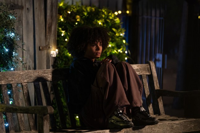 Jasmine Fisher, sitting on a bench in EastEnders