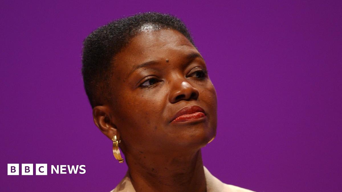 A mother holds her baby upright to rest on her shoulder