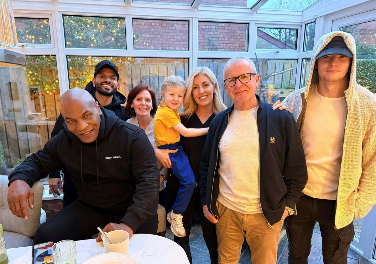 Kevin McKinney and his family in their North Belfast house with Mike Tyson