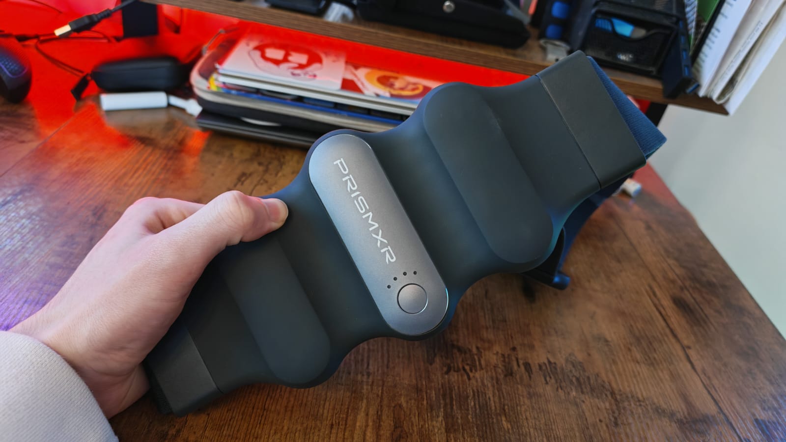 A reviewer holding up the PrismXR Carina charging belt