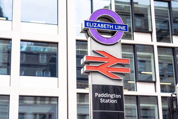 A sign for the new Elizabeth Line train service, also known as Crossrail, above a red British Rail logo at Paddington Station in London, one of the main interchanges of the service.