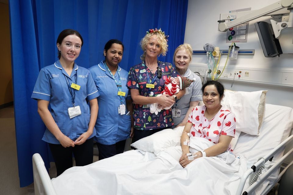 Ulster Hospital labour ward sister Tracy McAllister (holding Mirrah) with her staff and mum Jesna