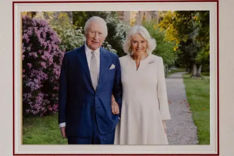 Reuters King Charles and Queen Camilla in a garden in Rome in a picture for their Christmas card