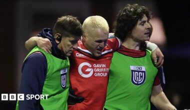 Blair Murray is helped from the field during Scarlets' win at Cardiff