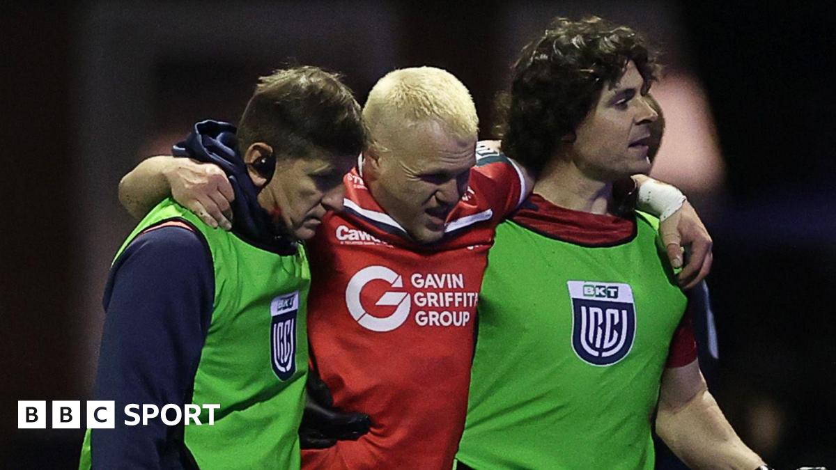 Blair Murray is helped from the field during Scarlets' win at Cardiff