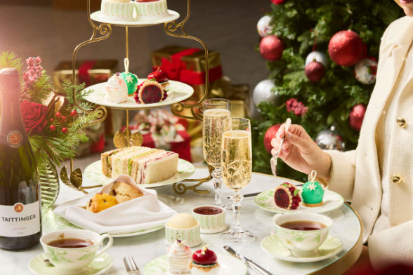 festive afternoon tea spread with sandwhiches, champagne and scones