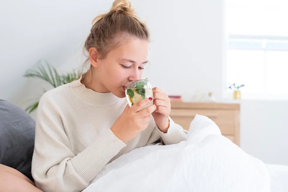 A young woman with a cup of mint tea.