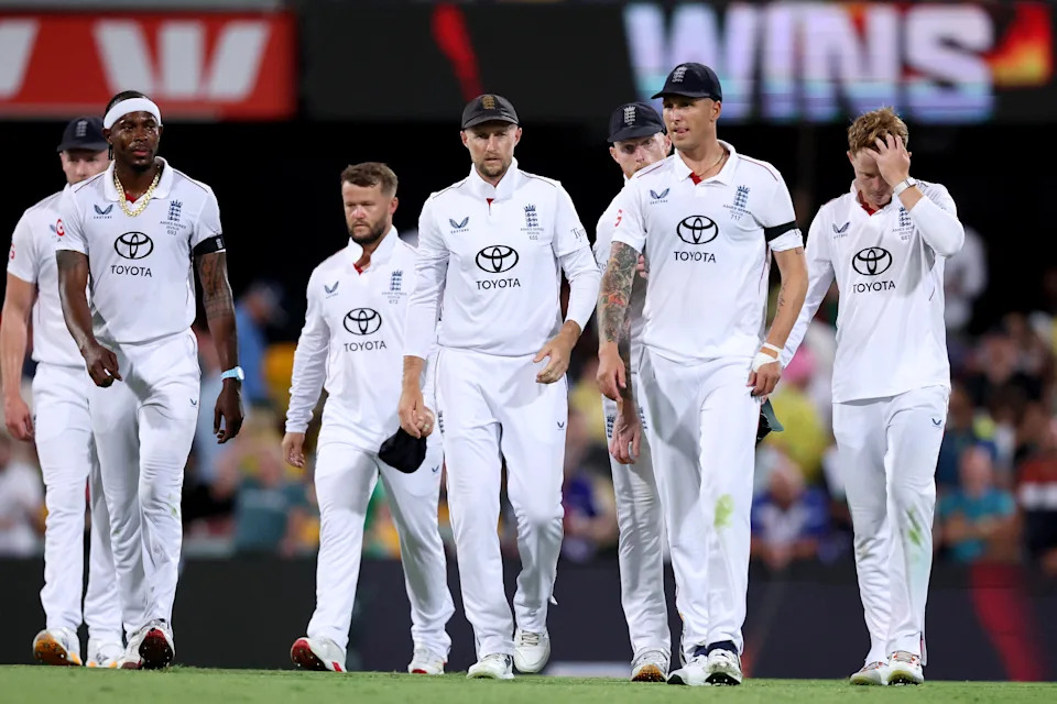 Joe Root walks with teammates.