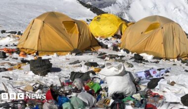 Camp IV on Everest. A cluster of yellow tents surrounded by snow and rubbish.