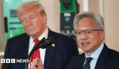 US President Donald Trump (L) listens as Nvidia CEO Jensen Huang speaks to an audience through a microphone in front of him
