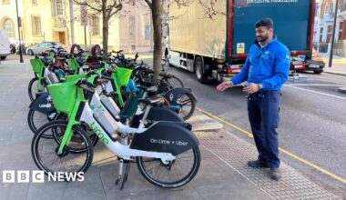 Numerous e-bikes are lined up in a row. Some are from Lime, others are from Bolt.