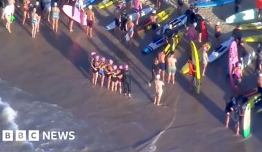 An aerial grab from video shows swimmers standing on the beach next to surfers with their boards before they paddle out, in Bondi on Friday.