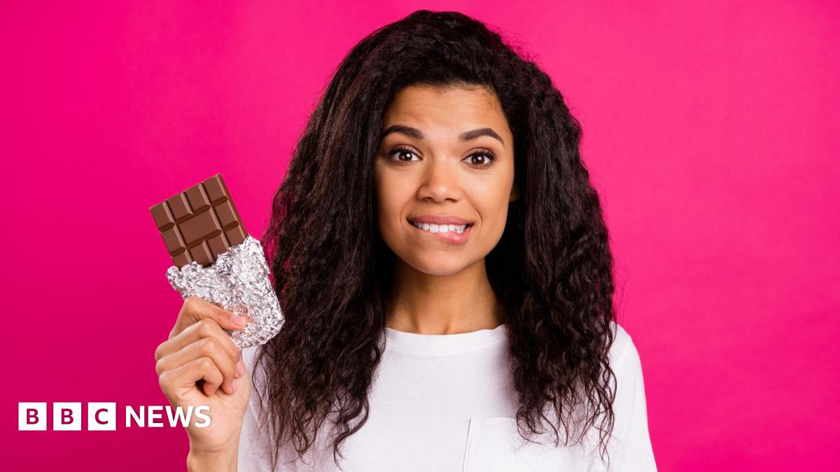 In this photograph illustration a bar of Cadbury's Dairy Milk chocolate without a wrapper is broken in half