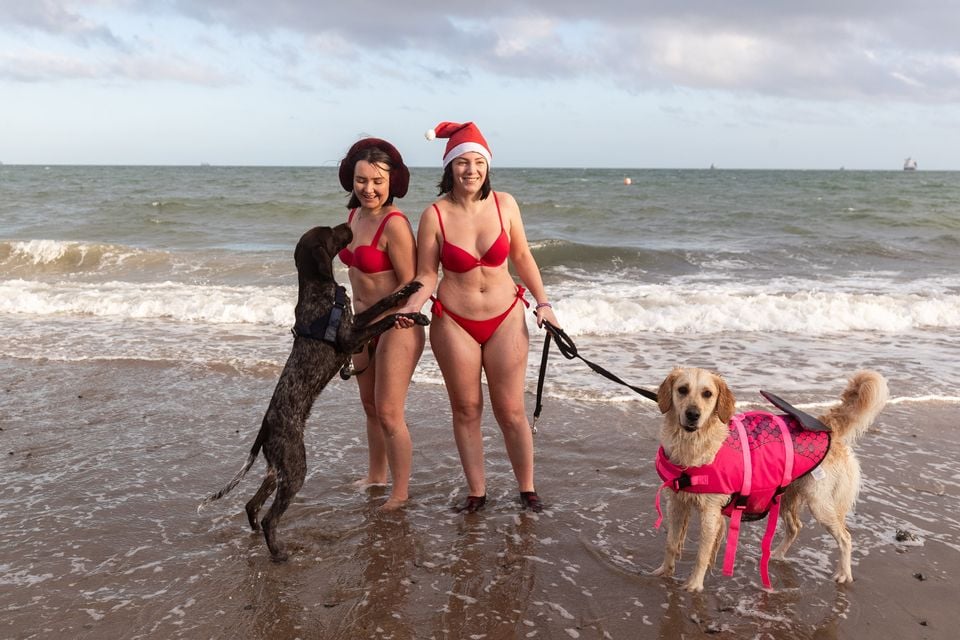 Stephanie Finnegan with dog Summer and Emma Cole with her dog Hugo at Helen’s Bay on 24th December 2025 (Luke Jervis/Belfast Telegraph)