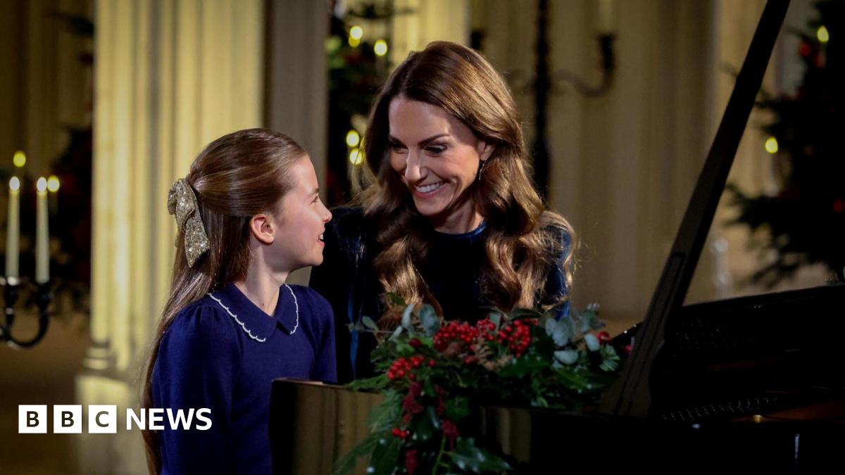 Princess Charlotte and Catherine, The Princess of Wales, sit smiling at a piano as they perform at for a Christmas Carol service