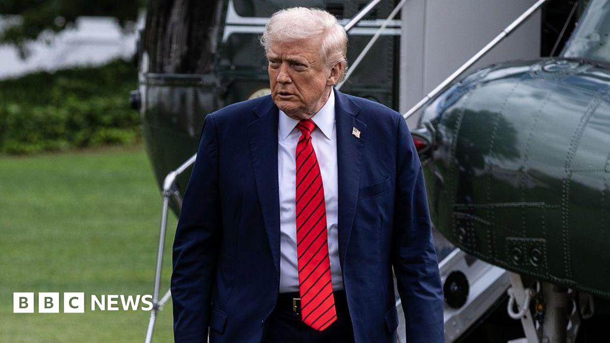 Donald Trump walks away from a helicopter wearing a suit and red tie after he returns to the White House following a visit to Walter Reed National Military Medical Center on 10 October 2025.