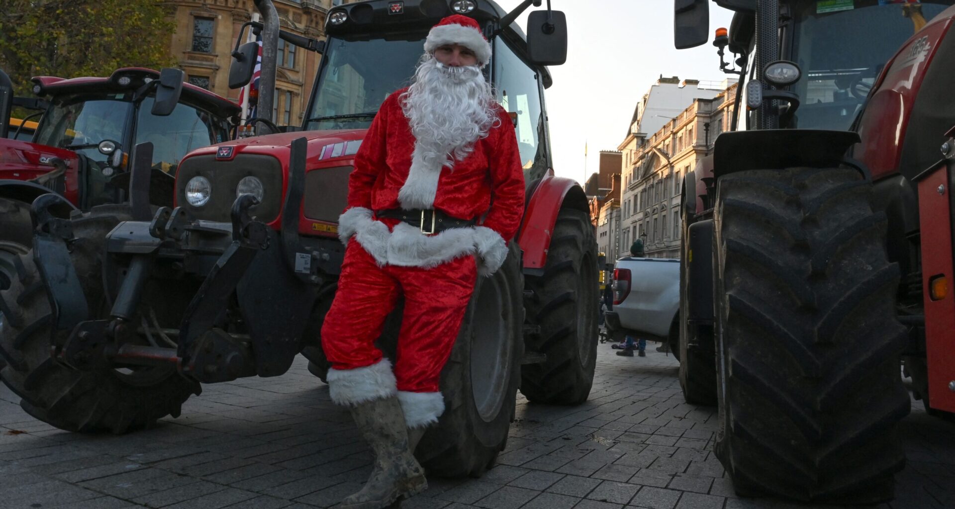 A farmer, wearing Santa costume, is seen as farmers from different regions of the United Kingdom gather with their tractors to protest on budget day, demanding fair reforms in agricultural policies and the reversal of changes to inheritance tax in London on November 26, 2025.