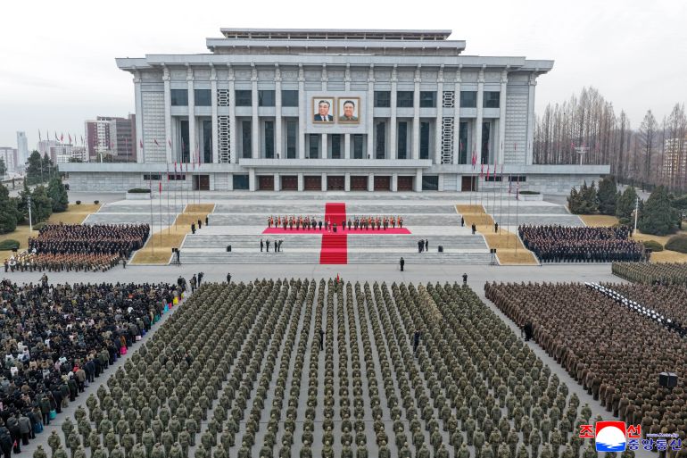 This picture taken on December 12, 2025 and released from North Korea's official Korean Central News Agency (KCNA) on December 13 shows North Korean leader Kim Jong Un (at podium) attending a welcoming ceremony for the Korean People's Army's 528th Regiment of Engineers, which returned from an overseas deployment in Russia's Kursk region during Moscow's war with Ukraine, in front of the April 25 House of Culture in Pyongyang. (Photo by KCNA VIA KNS / AFP) / South Korea OUT / SOUTH KOREA OUT / SOUTH KOREA OUT / ---EDITORS NOTE--- RESTRICTED TO EDITORIAL USE - MANDATORY CREDIT "AFP PHOTO/KCNA VIA KNS" - NO MARKETING NO ADVERTISING CAMPAIGNS - DISTRIBUTED AS A SERVICE TO CLIENTS / THIS PICTURE WAS MADE AVAILABLE BY A THIRD PARTY. AFP CAN NOT INDEPENDENTLY VERIFY THE AUTHENTICITY, LOCATION, DATE AND CONTENT OF THIS IMAGE --- /
