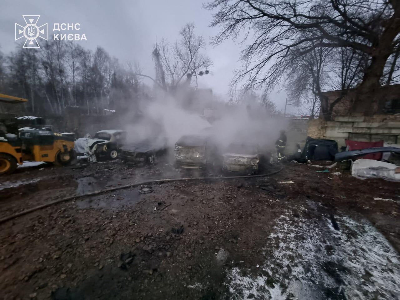 A firefighter works at the site of a car repair workshop damaged during Russian missile and drone strikes, amid Russia's attack on Ukraine, in Kyiv, Ukraine 27 December 2025