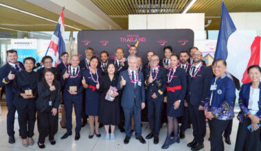 Air France crew and TAT representatives posing together with garlands during the Paris–Phuket inaugural flight welcome at Phuket International Airport.