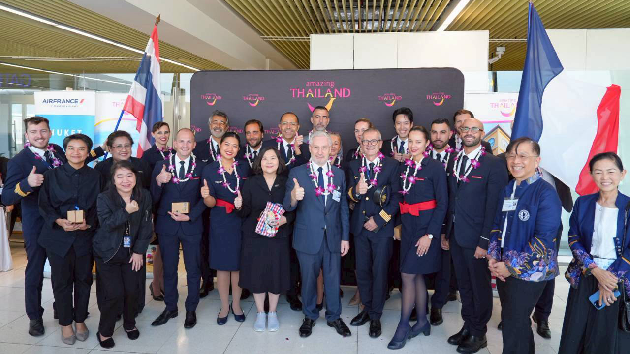 Air France crew and TAT representatives posing together with garlands during the Paris–Phuket inaugural flight welcome at Phuket International Airport.