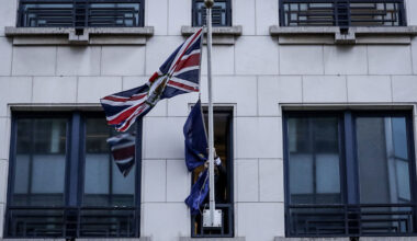 An official removes the European Union flag from the United Kingdom Representation to the EU building in Brussels, on Brexit Day, January 31, 2020