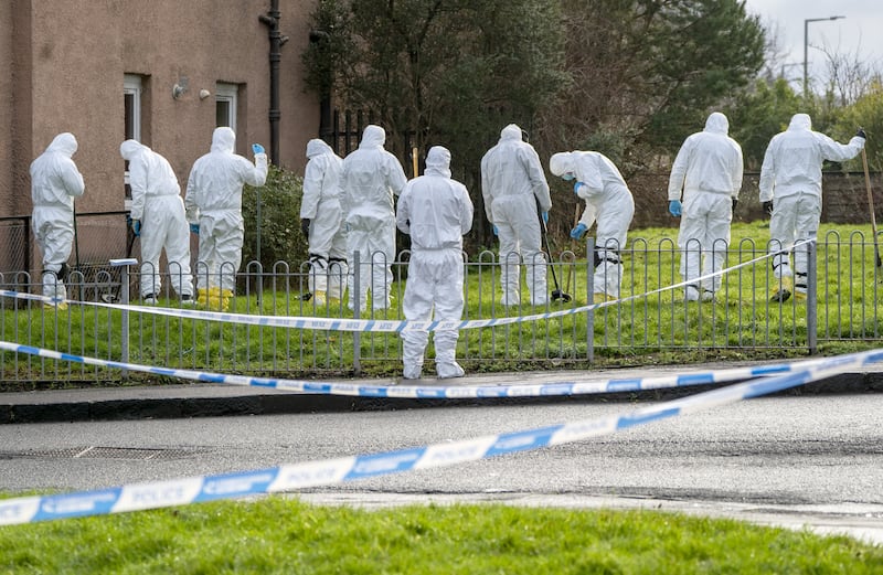 Police forensic officers searching near the scene in January 2024