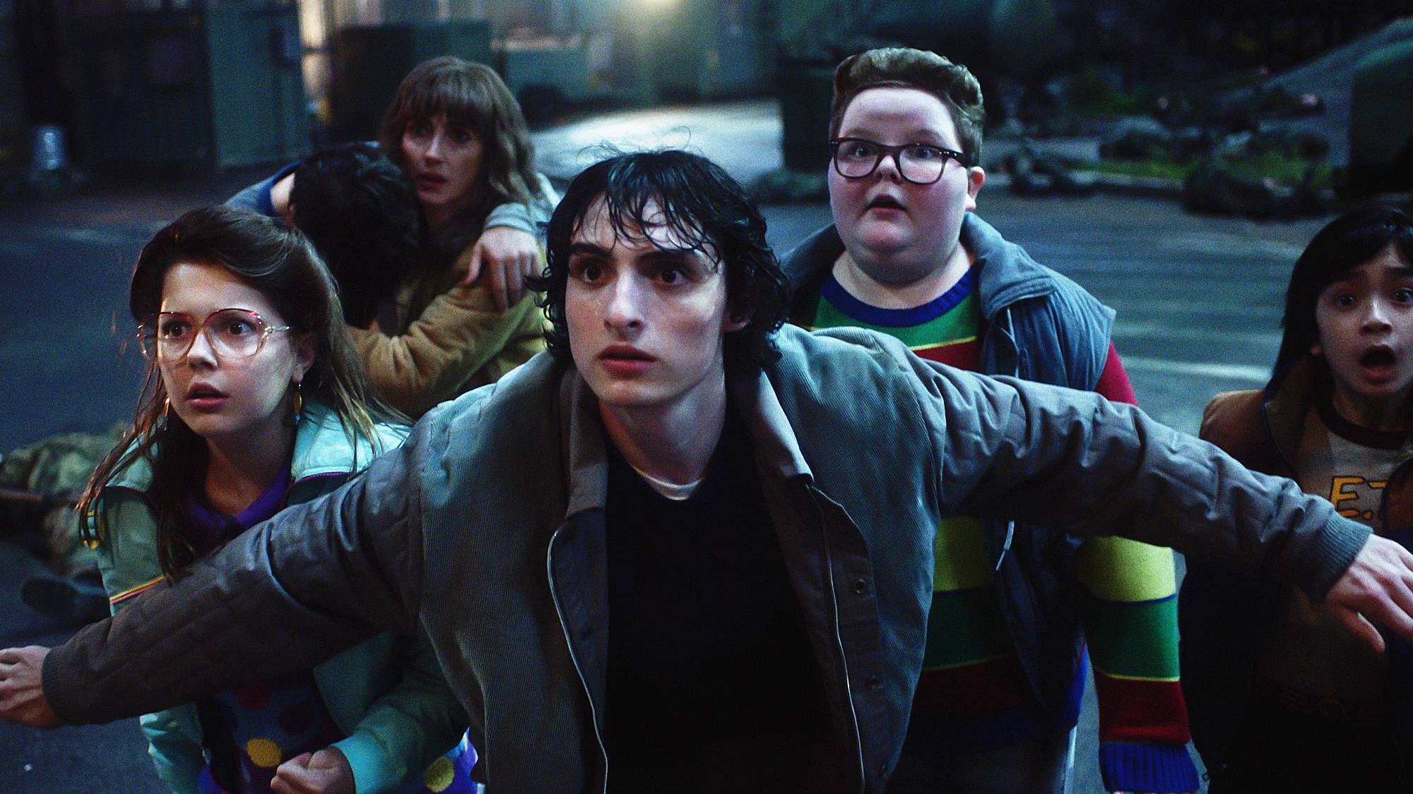 Winona Ryder as Joyce Byers, Finn Wolfhard as Mike Wheeler and Jake Connelly as Derek in "Stranger Things" season 5