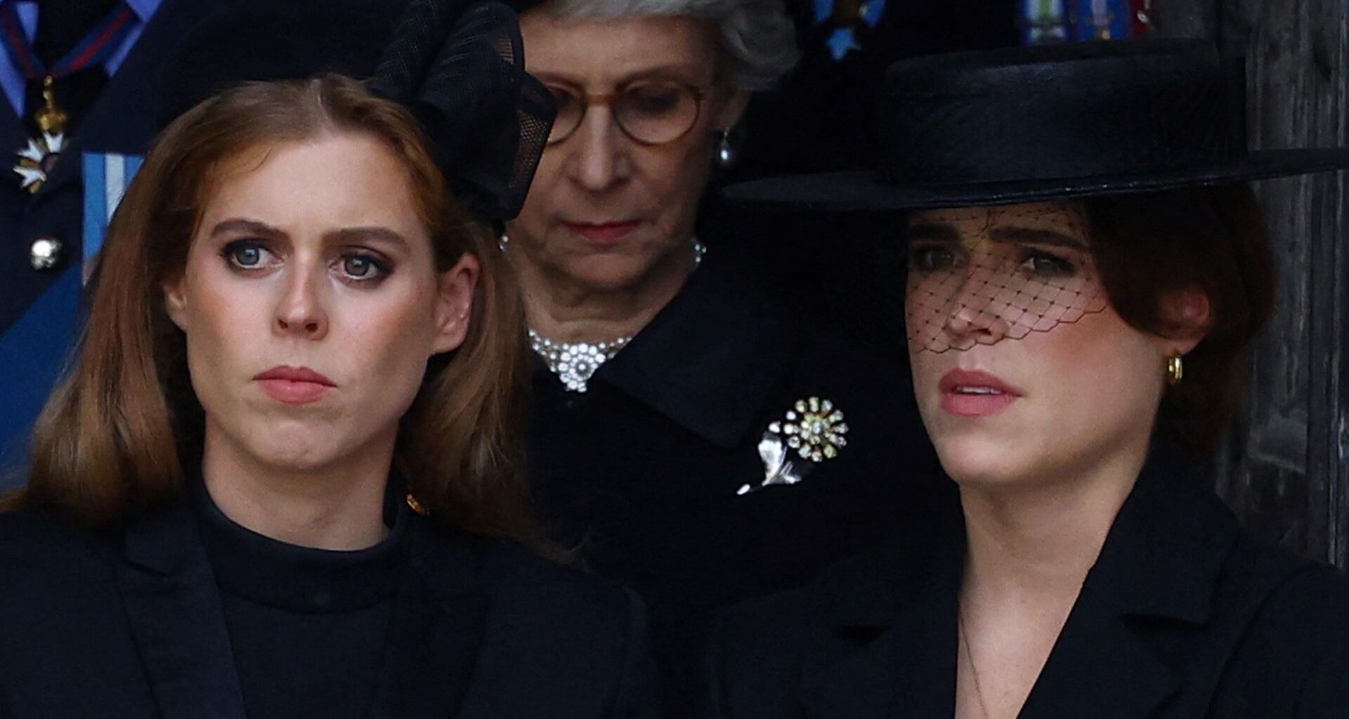Princess Beatrice and Princess Eugenie both look serious while wearing black outfits