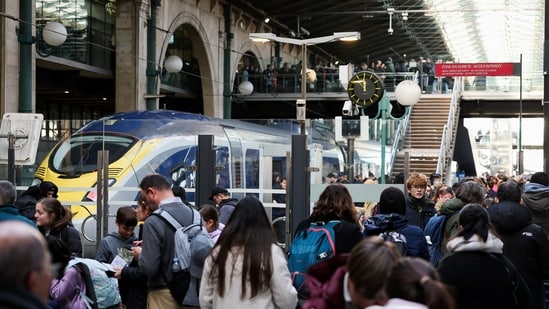 People gather near a Eurostar train at Gare du Nord station, after Eurostar announced a power supply problem in the Channel Tunnel that links Britain and France, in Paris, France, December 30, 2025.(REUTERS)