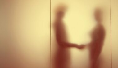 A blurred image of two people shaking hands behind a wall
