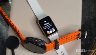 A Galaxy Fit 3 rests alongside a Galaxy Watch Ultra.