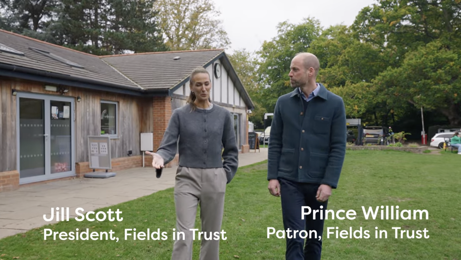 Prince William and Jill Scott walking in a field