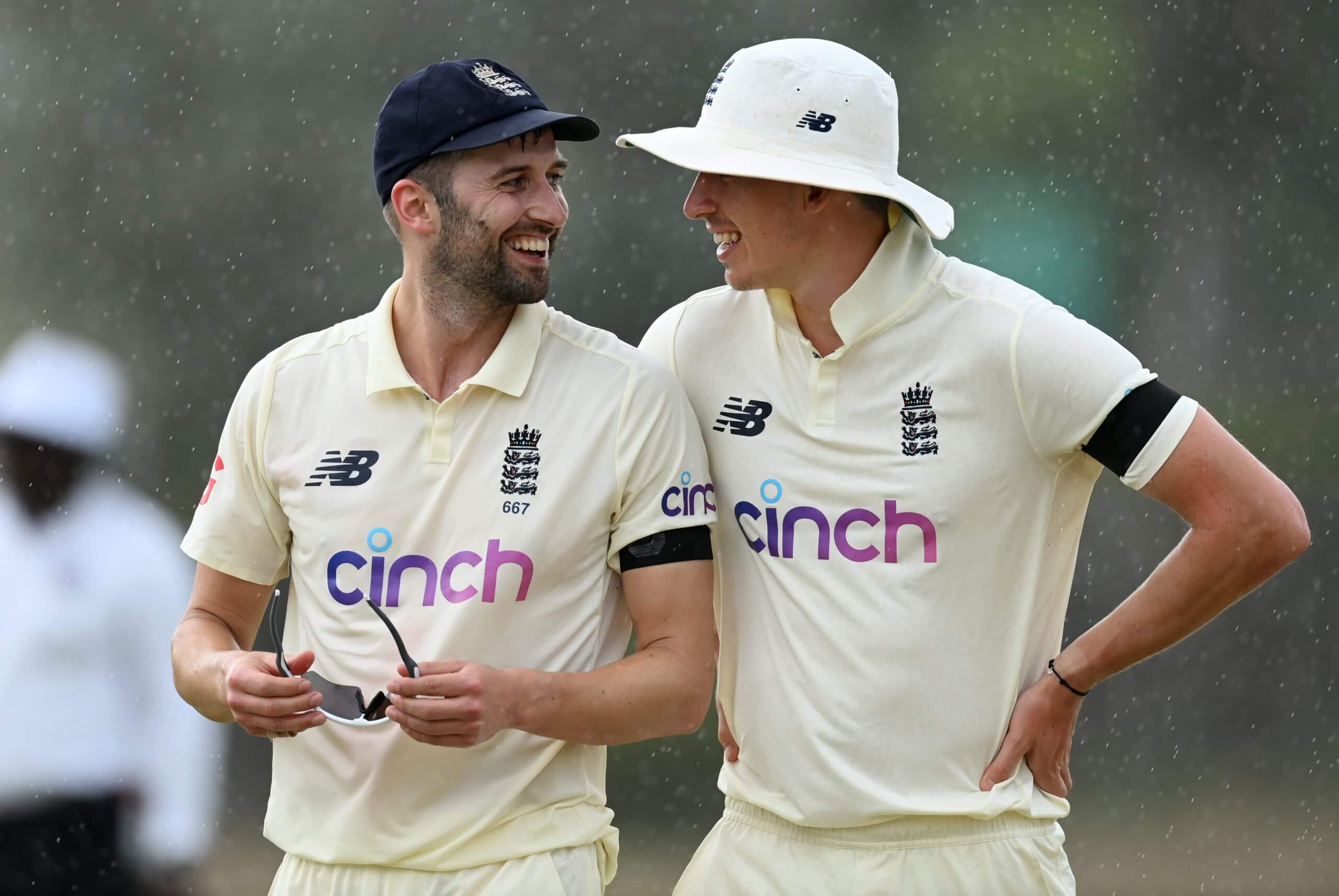 Matthew Fisher talks to Mark Wood, the man he has replaced in the Ashes party, in Antigua in March 2022