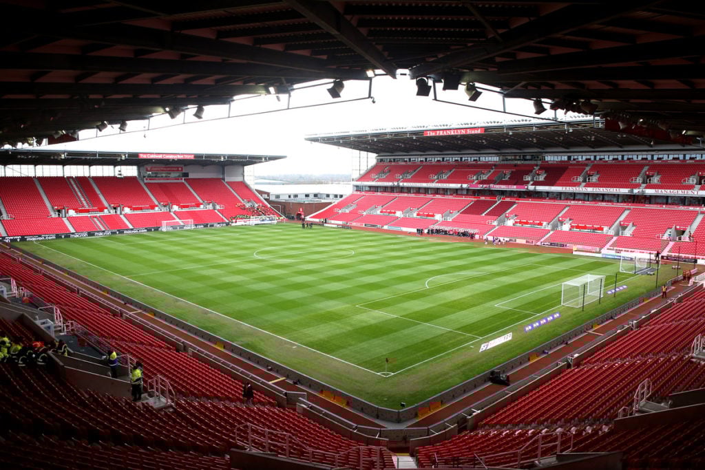 Stoke City stadium with a green pitch and red seating