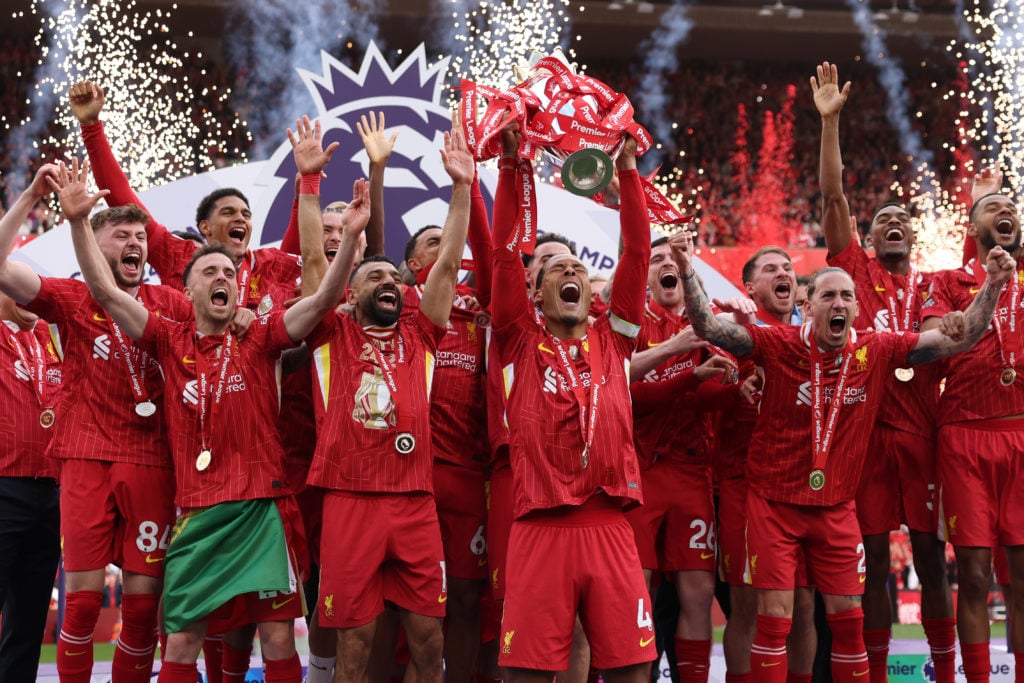Virgil van Dijk lifts the Premier League trophy surrounded by Liverpool players on the final day of the 2024/25 season at Anfield.