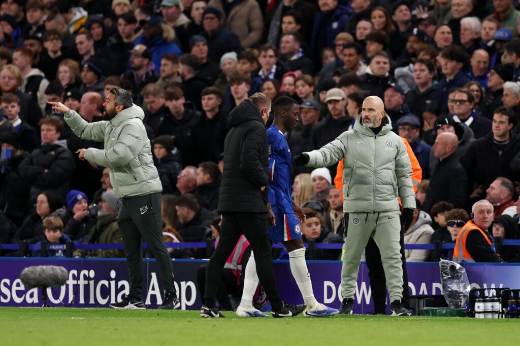 Moises Caicedo of Chelsea is greeted by his manager Enzo Maresca, as he walks off the pitch after being shown a red card